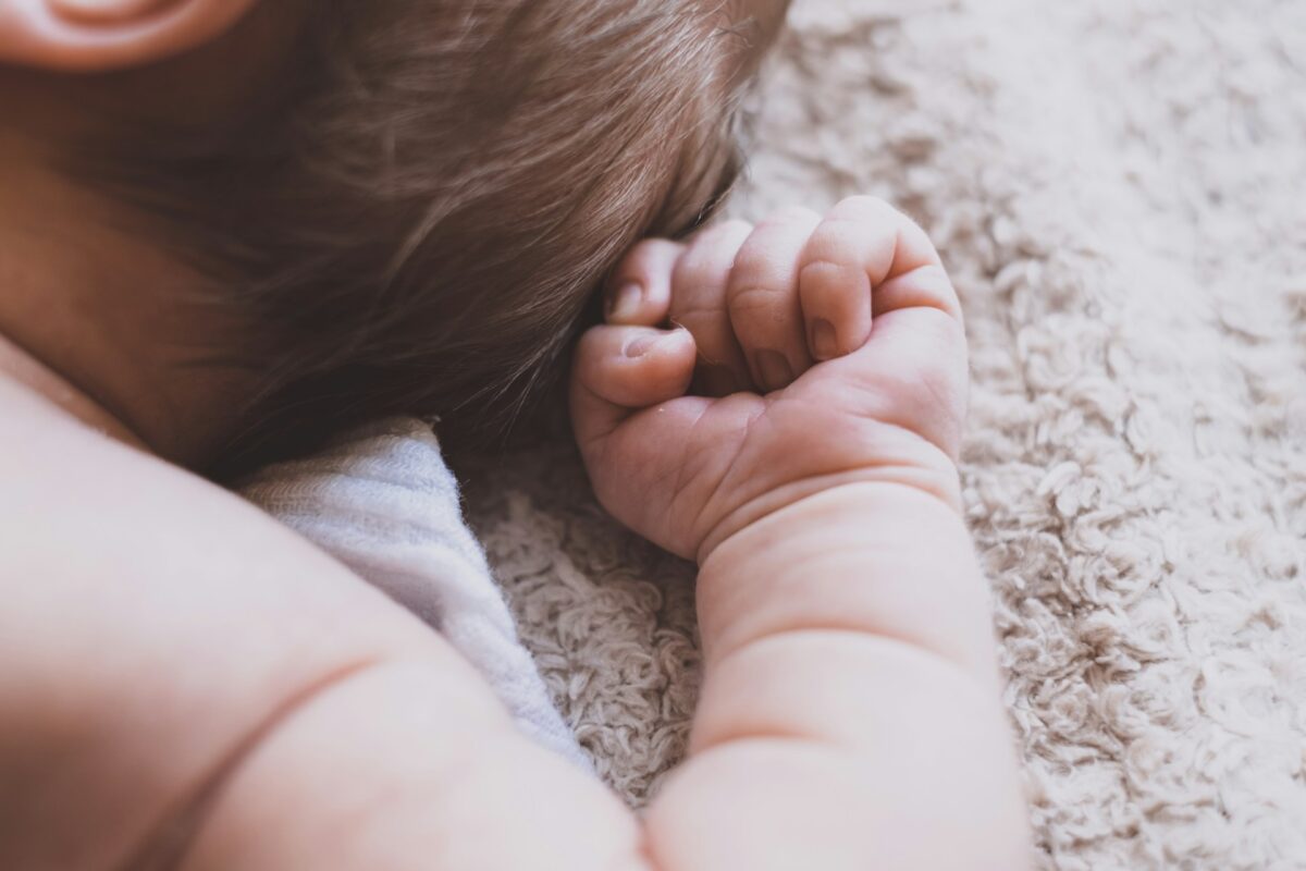 Sleeping baby making a fist